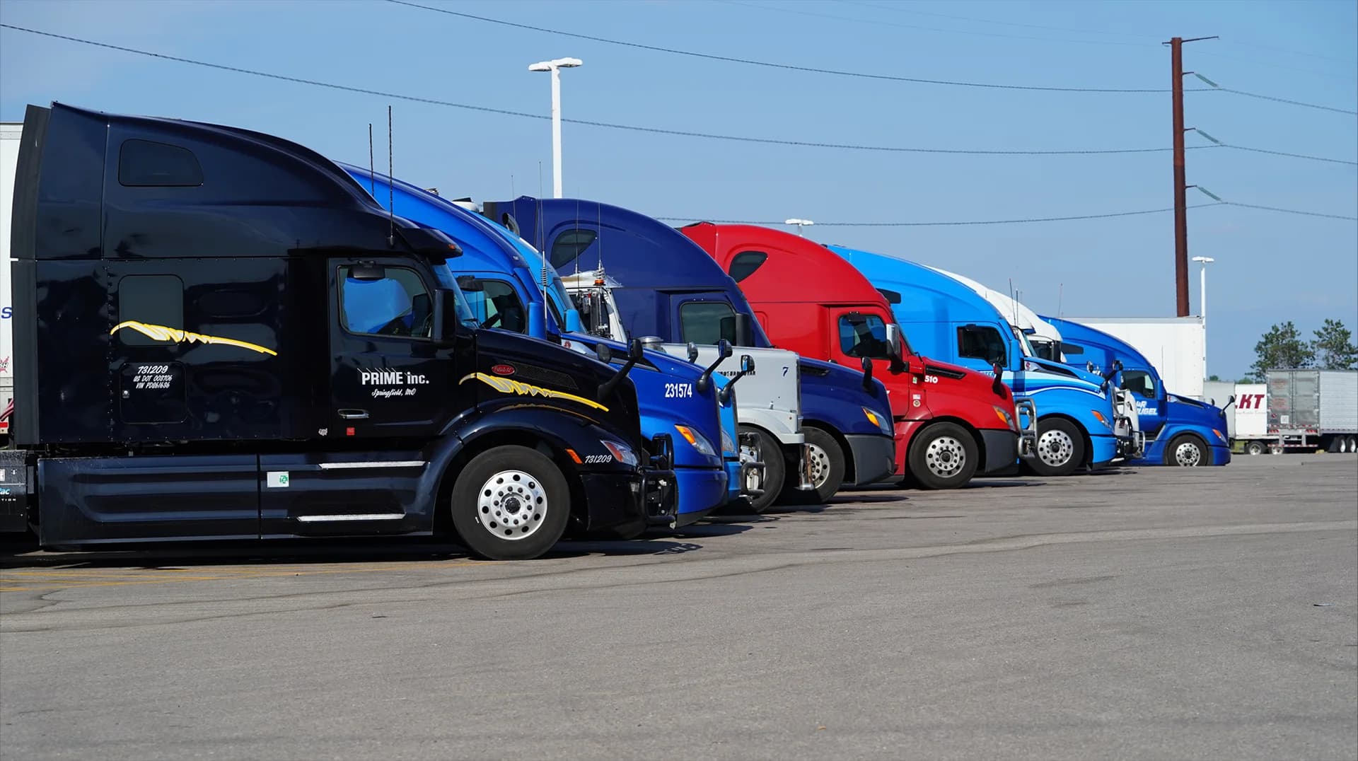 Cargo vans and box trucks at sunrise in logistics yard